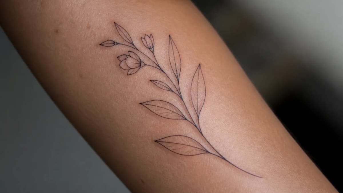 Delicate flowering branch with fine leaves, minimalist linework style.